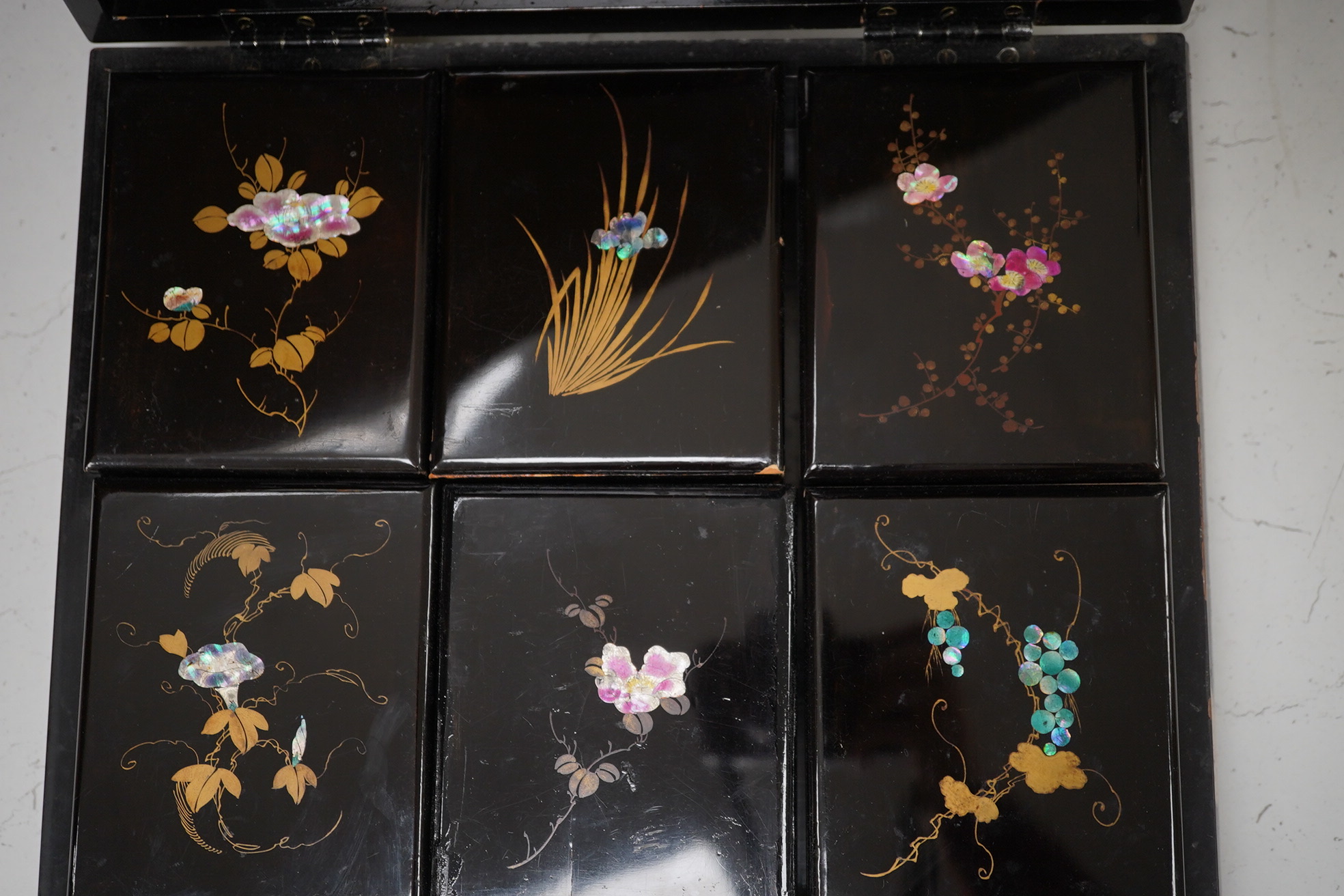 A Japanese lacquered box with mother of pearl inlay of birds and flowers, 35.5cm wide. Condition - worn on the outside to be expected, inside good